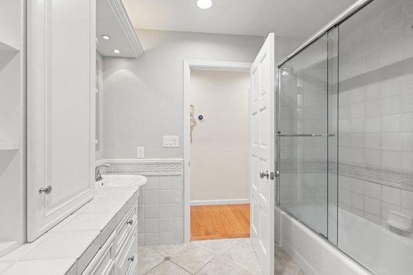 Bathroom, Glass Shower, Interior, Recessed Lighting, Tile Countertops, Wood Texture Flooring