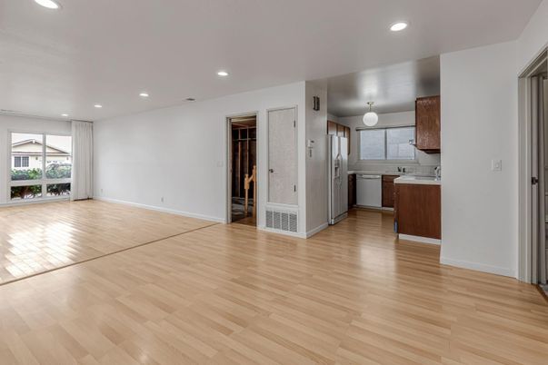 Empty room, Interior, Kitchen, Recessed Lighting, Stainless Steel Appliances, Wood Texture Flooring