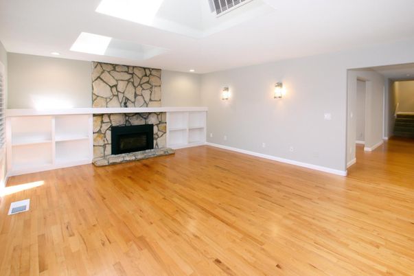Empty room, Fireplace, Interior, Recessed Lighting, Stone Walls, Wood Texture Flooring