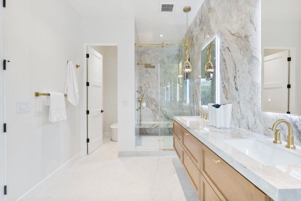 Bathroom, Dual Sink Vanities, Glass Shower, Interior, Marble, Marble Walls, Pendant Lights, Recessed Lighting