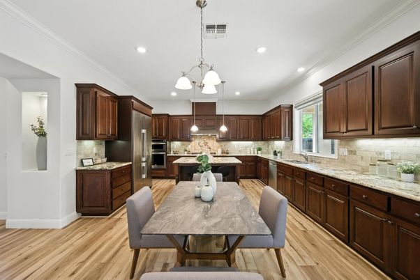 Chandelier, Dining room, Interior, Kitchen, Pendant Lights, Recessed Lighting, Stainless Steel Appliances, Wood Texture Flooring