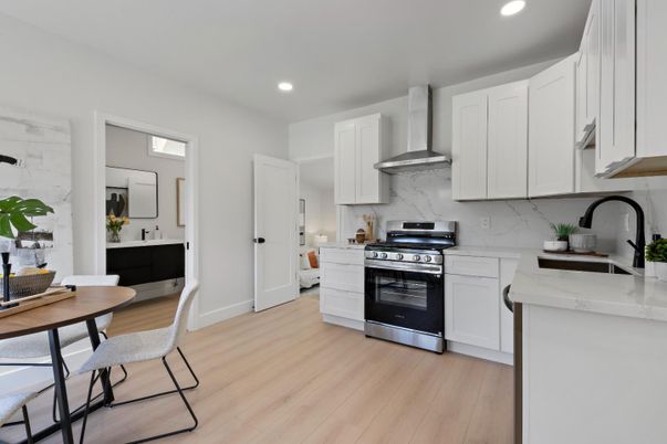 Interior, Kitchen, Marble Walls, Recessed Lighting, Stainless Steel Appliances, Wood Texture Flooring