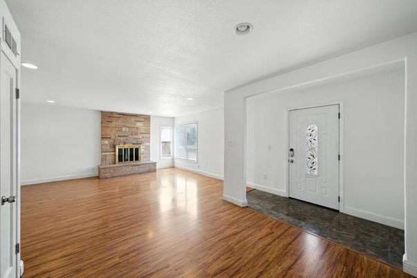 Empty room, Fireplace, Interior, Recessed Lighting, Stone Walls, Wood Texture Flooring