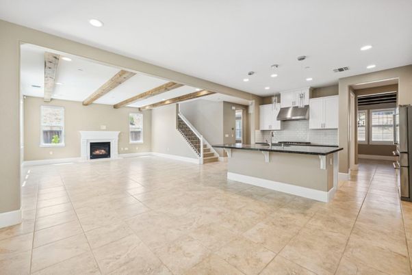 Empty room, Fireplace, Interior, Kitchen, Pendant Lights, Recessed Lighting, Stainless Steel Appliances, Wooden Beams