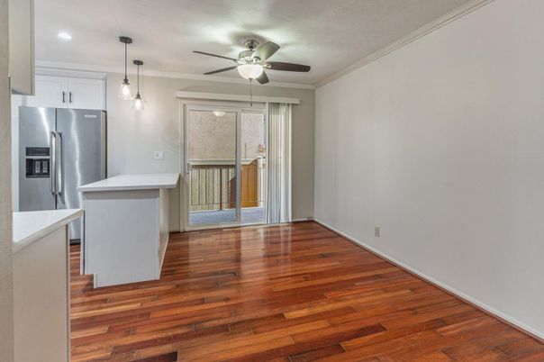 Empty room, Interior, Kitchen, Pendant Lights, Recessed Lighting, Stainless Steel Appliances, Wood Texture Flooring