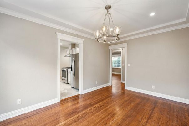 Empty room, Interior, Kitchen, Pendant Lights, Recessed Lighting, Stainless Steel Appliances, Wood Texture Flooring