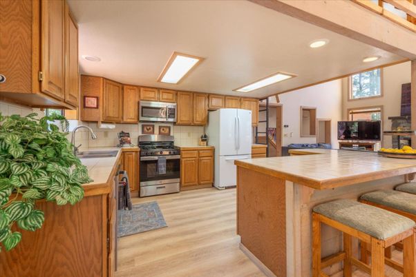 Interior, Kitchen, Recessed Lighting, Stainless Steel Appliances, Tile Countertops, Wood Texture Flooring