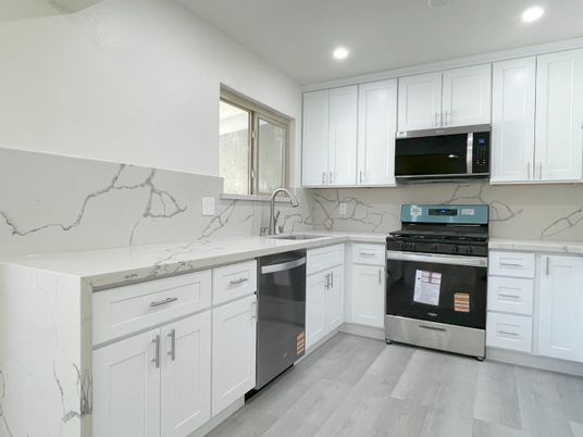 Interior, Kitchen, Marble Walls, Recessed Lighting, Stainless Steel Appliances, Wood Texture Flooring