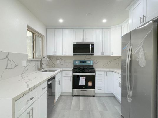 Interior, Kitchen, Marble Walls, Recessed Lighting, Stainless Steel Appliances, Wood Texture Flooring