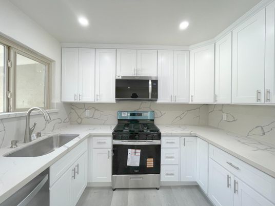 Interior, Kitchen, Marble Walls, Recessed Lighting, Stainless Steel Appliances, Wood Texture Flooring