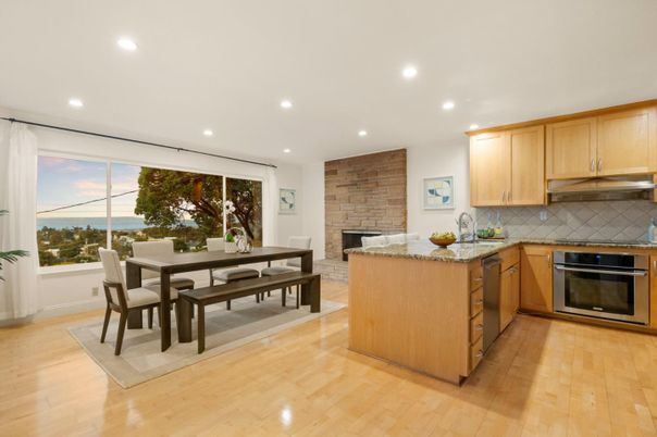 Dining room, Fireplace, Interior, Kitchen, Recessed Lighting, Stainless Steel Appliances, Stone Walls, Water, Wood Texture Flooring
