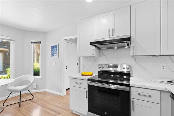 Interior, Kitchen, Marble Walls, Recessed Lighting, Stainless Steel Appliances, Wood Texture Flooring