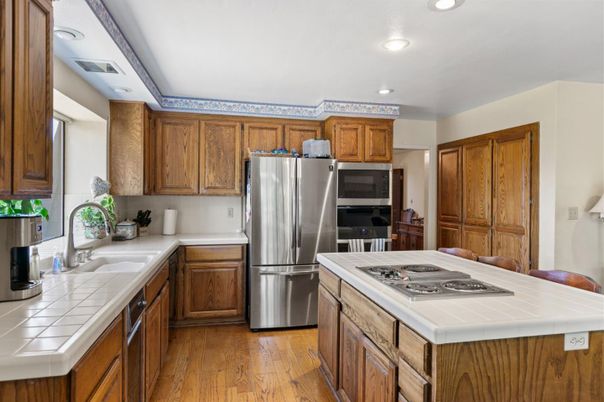 Interior, Kitchen, Recessed Lighting, Stainless Steel Appliances, Tile Countertops, Wood Texture Flooring