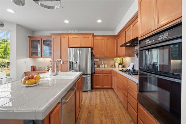 Interior, Kitchen, Recessed Lighting, Stainless Steel Appliances, Tile Countertops, Wood Texture Flooring