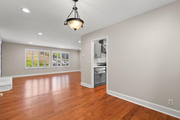 Empty room, Interior, Kitchen, Pendant Lights, Recessed Lighting, Stainless Steel Appliances, Wood Texture Flooring