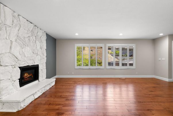 Empty room, Fireplace, Interior, Recessed Lighting, Stone Walls, Wood Texture Flooring