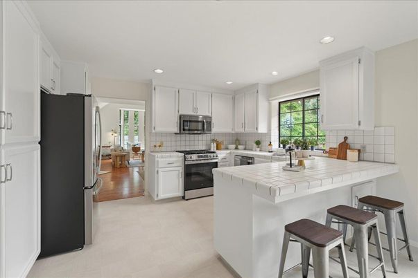 Interior, Kitchen, Recessed Lighting, Stainless Steel Appliances, Tile Countertops, Wood Texture Flooring