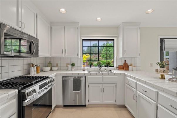Interior, Kitchen, Recessed Lighting, Stainless Steel Appliances, Tile Countertops, Wood Texture Flooring