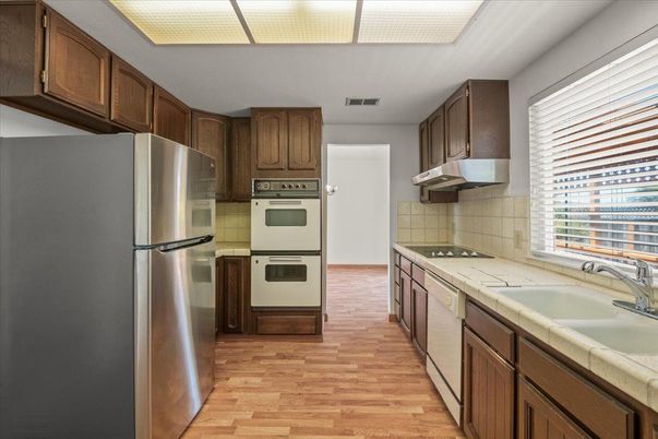 Interior, Kitchen, Stainless Steel Appliances, Tile Countertops, Wood Texture Flooring