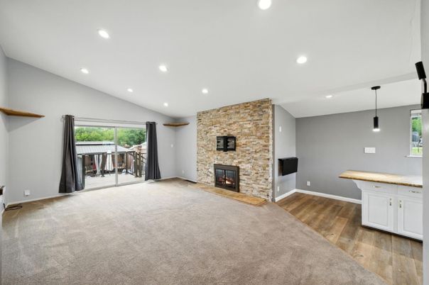 Empty room, Fireplace, Interior, Pendant Lights, Recessed Lighting, Stone Walls, Wood Texture Flooring