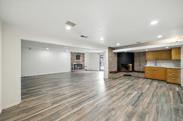 Empty room, Fireplace, Interior, Recessed Lighting, Stone Walls, Wood Texture Flooring