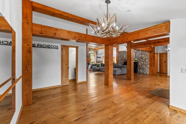 Chandelier, Empty room, Fireplace, Interior, Stone Walls, Wooden Beams, Wood Texture Flooring