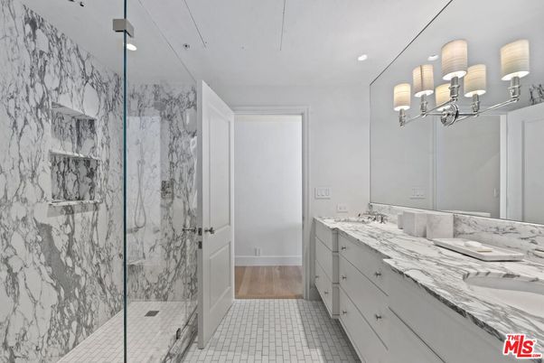 Bathroom, Dual Sink Vanities, Glass Shower, Interior, Marble Walls, Recessed Lighting, Wood Texture Flooring