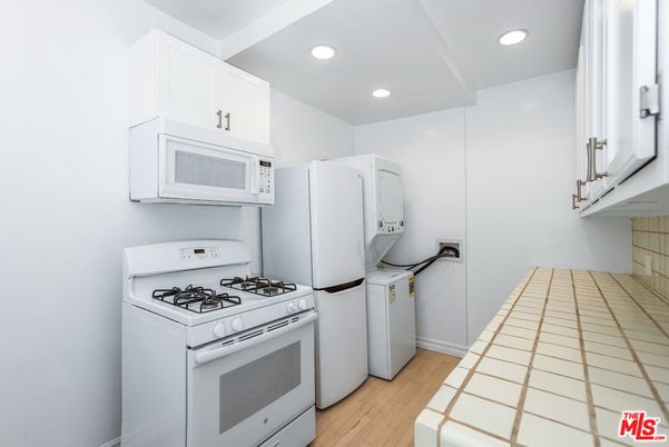 Interior, Kitchen, Recessed Lighting, Tile Countertops, Washer, Wood Texture Flooring