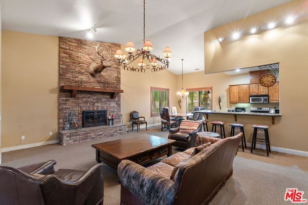 Chandelier, Dining room, Fireplace, Interior, Kitchen, Living room, Pendant Lights, Recessed Lighting, Stainless Steel Appliances, Stone Walls