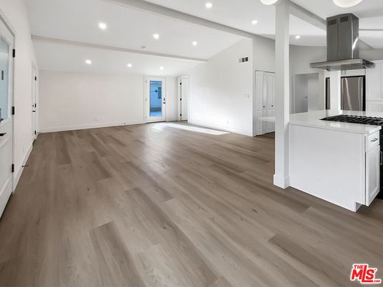 Empty room, Interior, Kitchen, Recessed Lighting, Stainless Steel Appliances, Wood Texture Flooring