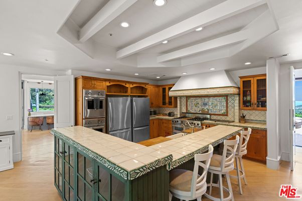 Interior, Kitchen, Recessed Lighting, Stainless Steel Appliances, Stone Walls, Tile Countertops, Wood Texture Flooring