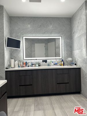 Bathroom, Dual Sink Vanities, Interior, Marble Walls, Recessed Lighting, Wood Texture Flooring