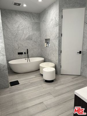 Bathroom, Free Standing Baths, Interior, Marble Walls, Recessed Lighting, Wood Texture Flooring
