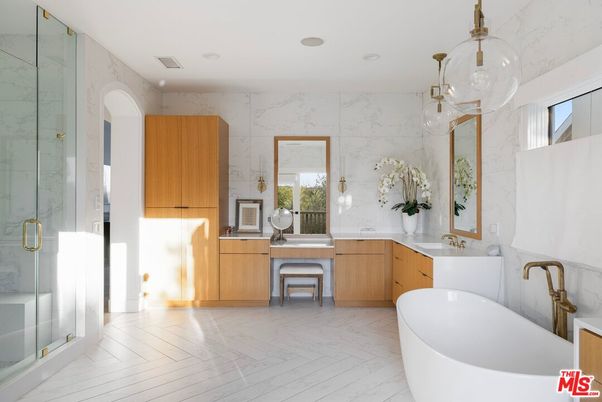 Bathroom, Dual Sink Vanities, Free Standing Baths, Glass Shower, Interior, Marble, Marble Walls, Pendant Lights, Recessed Lighting, Wood Texture Flooring