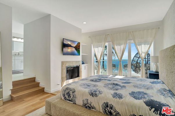Bedroom, Fireplace, Interior, Recessed Lighting, Water, Wood Texture Flooring