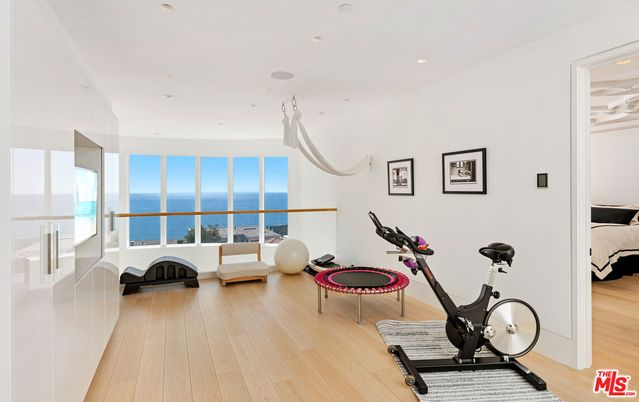 Bedroom, Fitness Equipment, Interior, Recessed Lighting, Water, Wood Texture Flooring