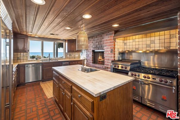 Fireplace, Interior, Kitchen, Pendant Lights, Recessed Lighting, Stainless Steel Appliances, Stone Walls, Water, Wooden Ceilings