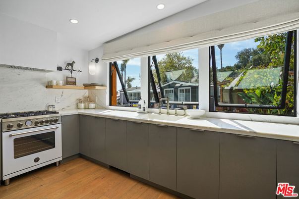 Interior, Kitchen, Marble Walls, Recessed Lighting, Stainless Steel Appliances, Wood Texture Flooring