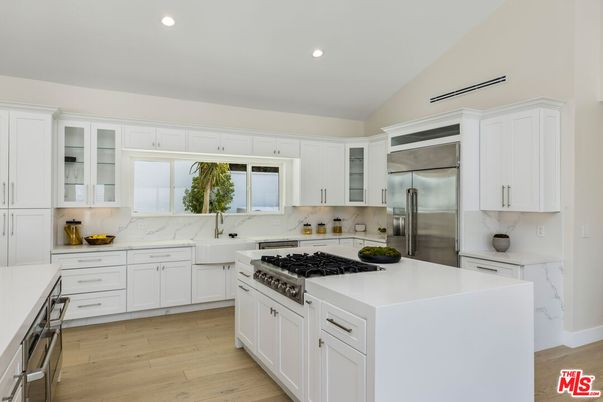 Interior, Kitchen, Marble Walls, Recessed Lighting, Stainless Steel Appliances, Wood Texture Flooring