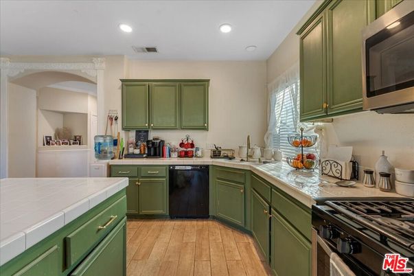 Interior, Kitchen, Recessed Lighting, Stainless Steel Appliances, Tile Countertops, Wood Texture Flooring