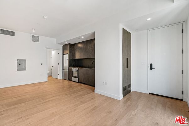 Empty room, Interior, Kitchen, Recessed Lighting, Stainless Steel Appliances, Wood Texture Flooring
