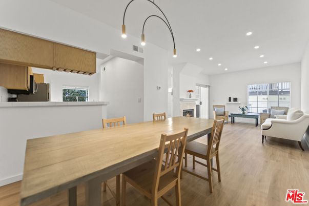 Dining room, Fireplace, Interior, Living room, Pendant Lights, Recessed Lighting, Wood Texture Flooring