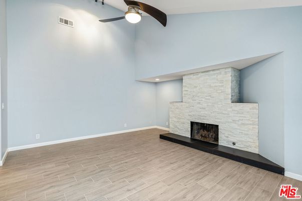 Empty room, Fireplace, Interior, Recessed Lighting, Stone Walls, Wood Texture Flooring