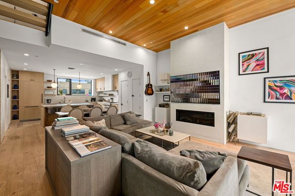 Fireplace, Interior, Kitchen, Living room, Pendant Lights, Recessed Lighting, Stainless Steel Appliances, Wooden Ceilings, Wood Texture Flooring