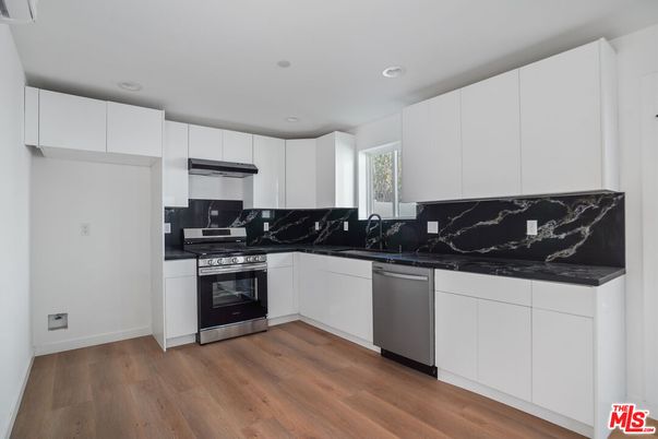 Interior, Kitchen, Marble Walls, Recessed Lighting, Stainless Steel Appliances, Wood Texture Flooring