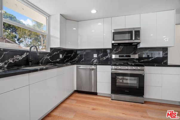 Interior, Kitchen, Marble Walls, Recessed Lighting, Stainless Steel Appliances, Wood Texture Flooring