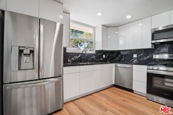 Interior, Kitchen, Marble Walls, Recessed Lighting, Stainless Steel Appliances, Wood Texture Flooring