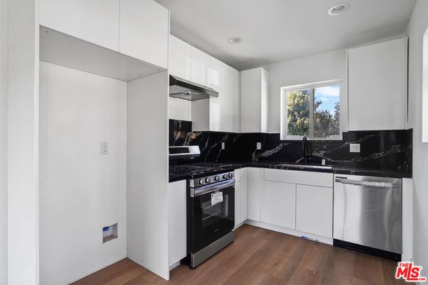 Interior, Kitchen, Marble Walls, Recessed Lighting, Stainless Steel Appliances, Wood Texture Flooring