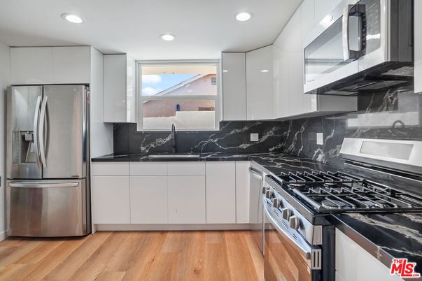 Interior, Kitchen, Marble Walls, Recessed Lighting, Stainless Steel Appliances, Wood Texture Flooring