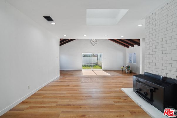 Empty room, Fireplace, Interior, Recessed Lighting, Stone Walls, Wooden Beams, Wood Texture Flooring